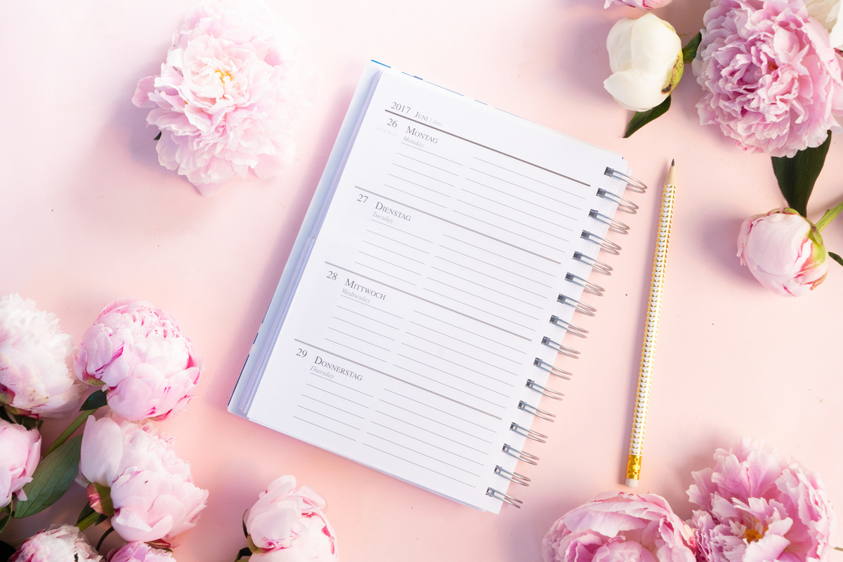 Planner, Pen, and Flowers Composition