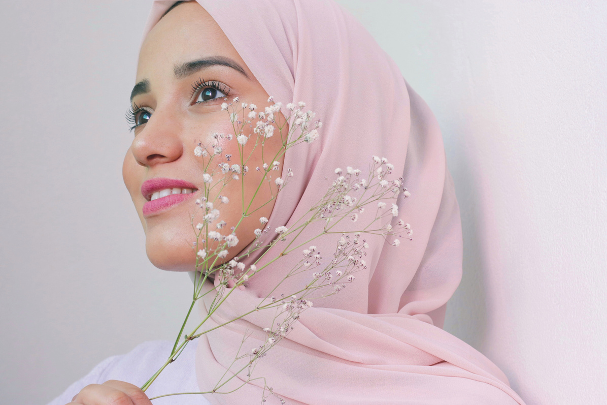 Smiling Woman Wearing Pink Hijab and White Flower\